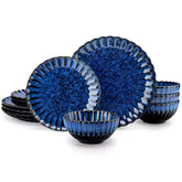 Blue reactive glaze stoneware bowls and plates from the Adonis 12 piece set with brown placemats and fresh flowers