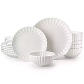 Adonis 18 piece white porcelain dinnerware set styled with food and glassware on a modern dining table