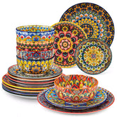 Lumi 18-piece Bohemian dinnerware set for six on a wooden table with colorful plates bowls and silverware in a playful Boho style