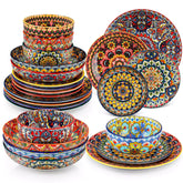 Bohemian style dining table set with Lumi 24 piece colorful dinnerware bowls and vibrant table décor ready for a lively meal