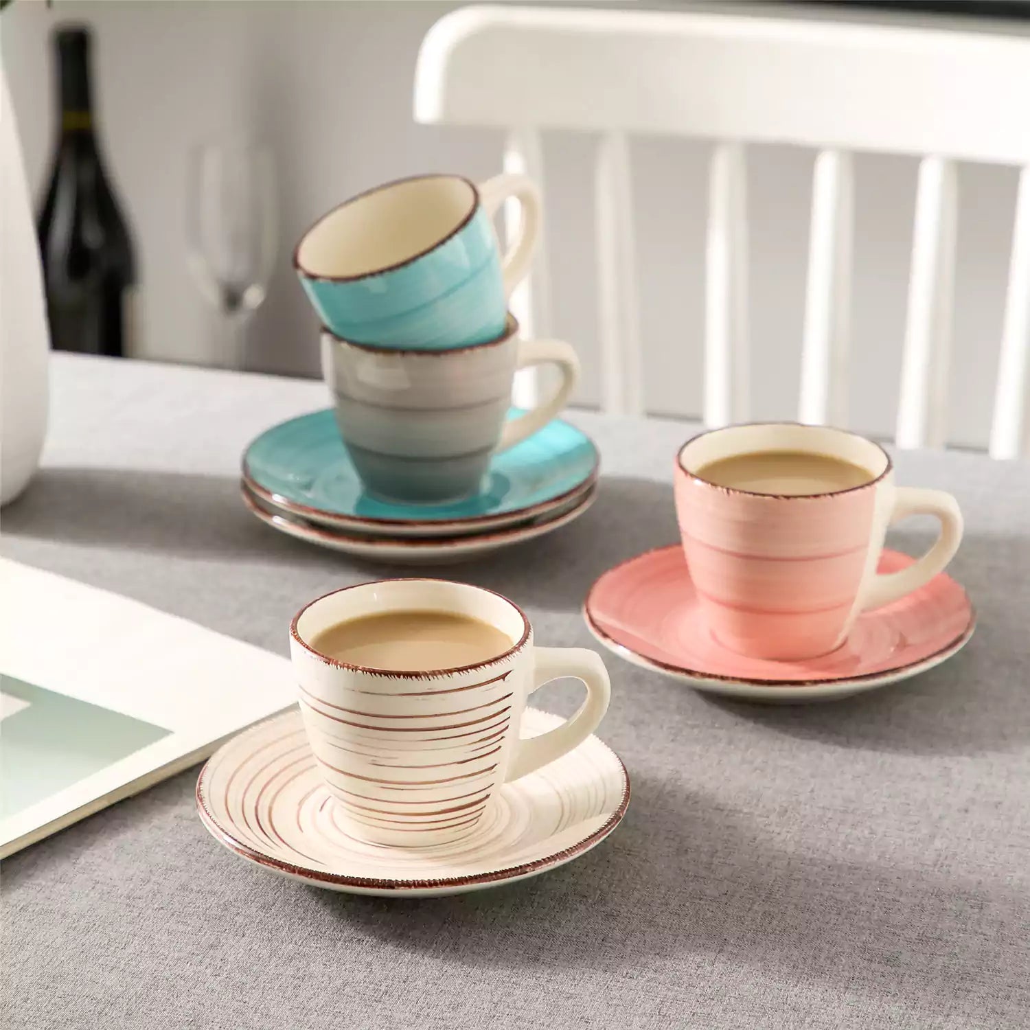 Steaming coffee served in colorful spiral stoneware cups and saucers-handmade vintage design - A