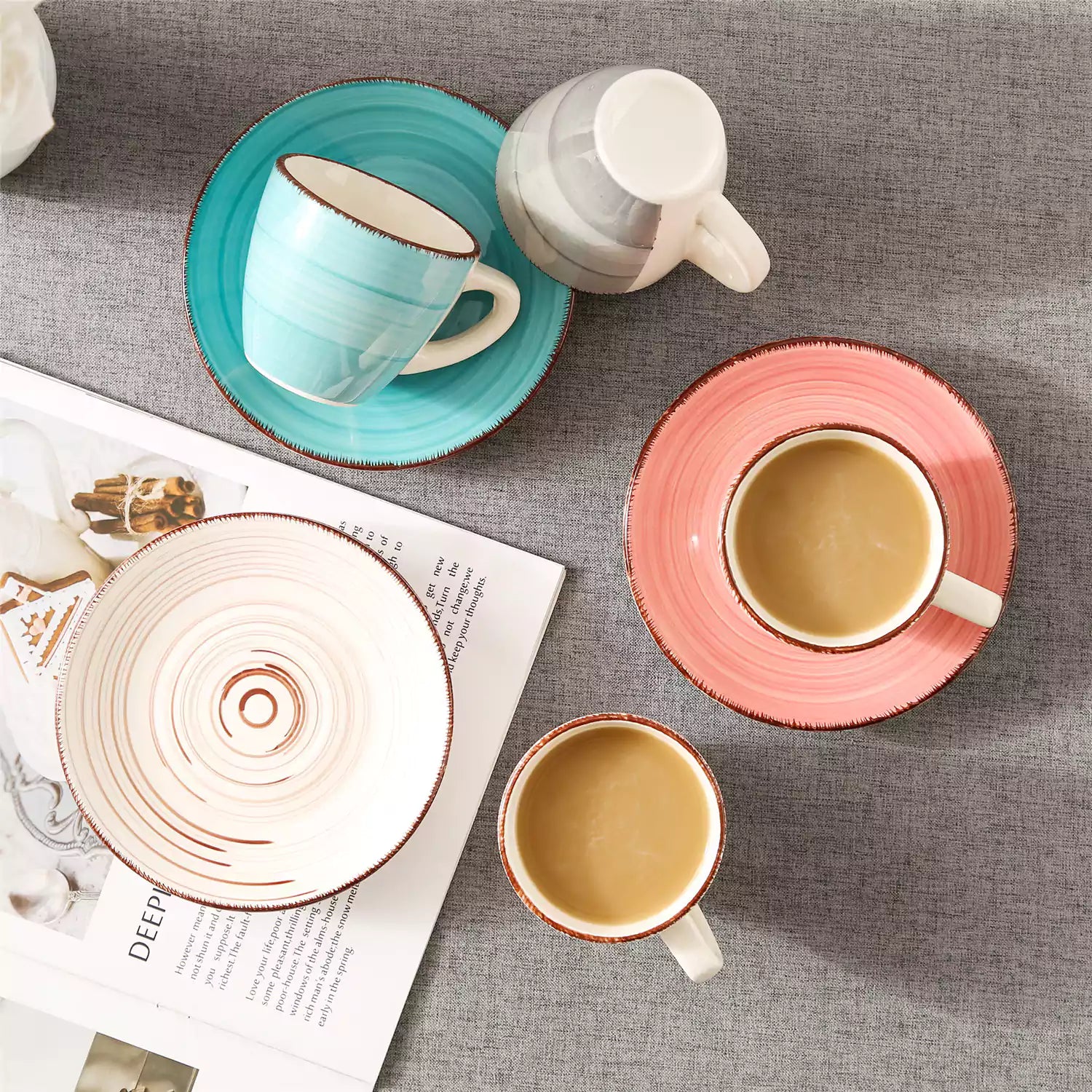Steaming coffee served in colorful spiral stoneware cups and saucers-handmade vintage design - A