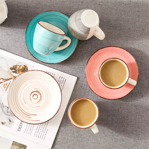 Steaming coffee served in colorful spiral stoneware cups and saucers-handmade vintage design - A