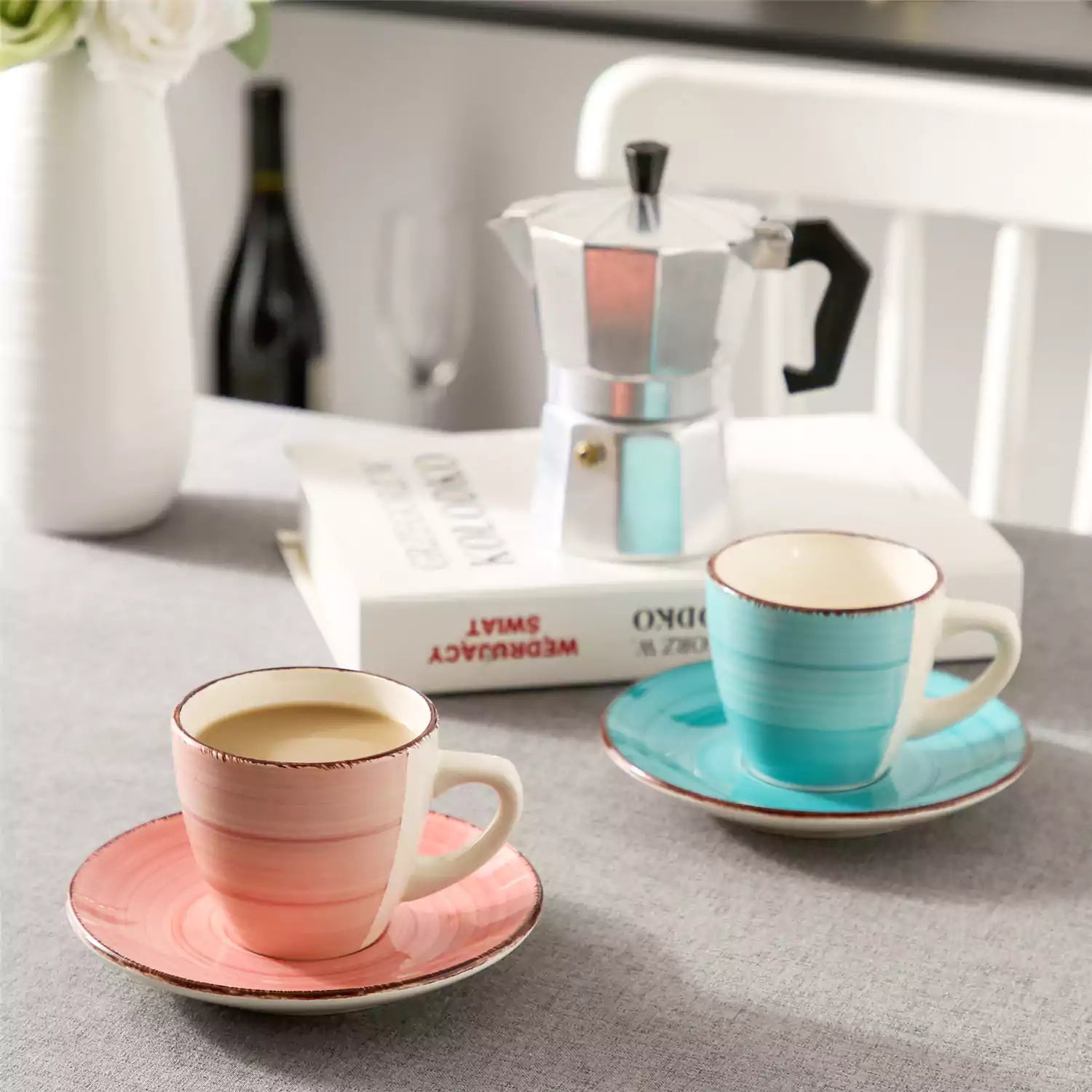 Steaming coffee served in colorful spiral stoneware cups and saucers-handmade vintage design - A