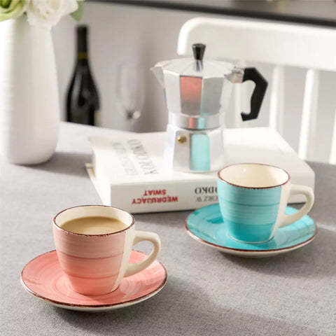 Steaming coffee served in colorful spiral stoneware cups and saucers-handmade vintage design - A