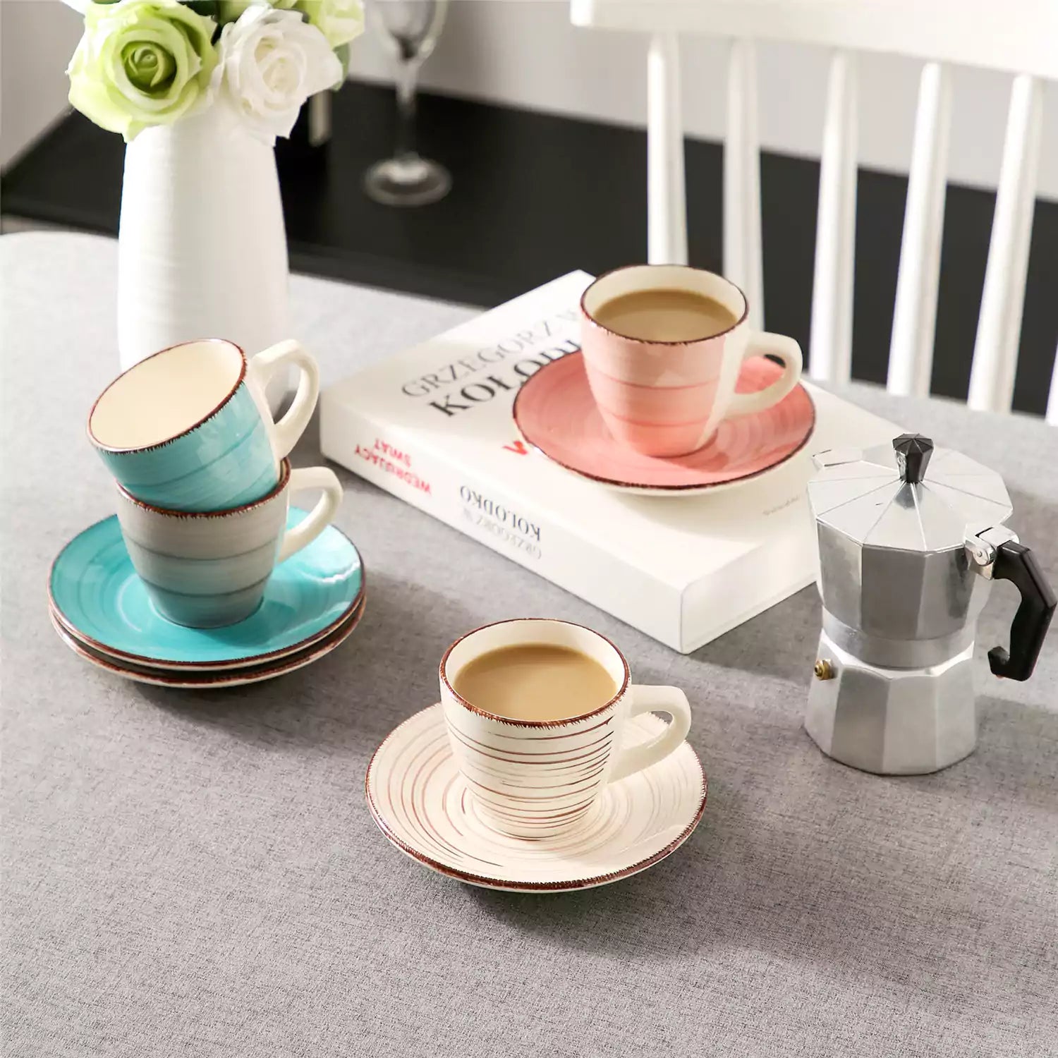 Steaming coffee served in colorful spiral stoneware cups and saucers-handmade vintage design - A