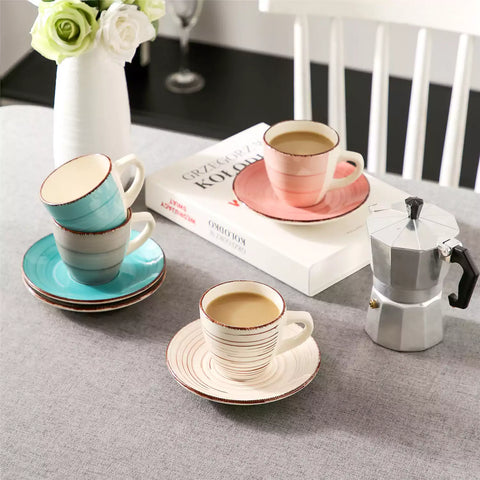 Steaming coffee served in colorful spiral stoneware cups and saucers-handmade vintage design - A