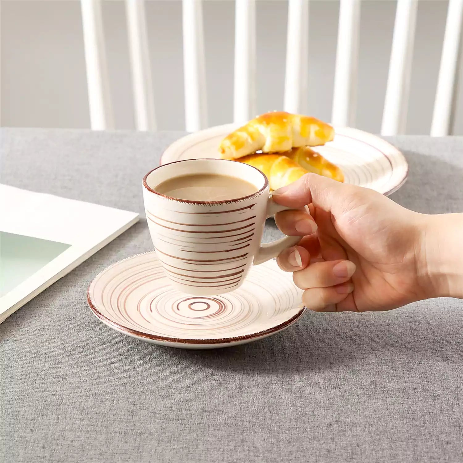 Steaming coffee served in colorful spiral stoneware cups and saucers-handmade vintage design - A