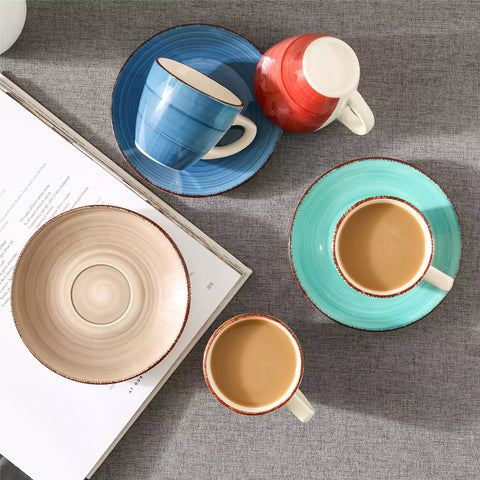 Steaming coffee served in colorful spiral stoneware cups and saucers-handmade vintage design - B