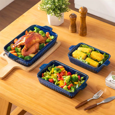 Starry 3 piece stoneware bakeware set with reactive glaze in navy blue on a wooden table