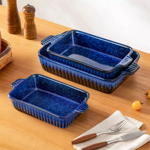 Starry 3 piece stoneware bakeware set with reactive glaze in navy blue on a wooden table
