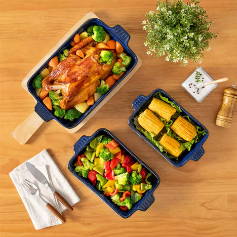 Starry 3 piece stoneware bakeware set with reactive glaze in navy blue on a wooden table