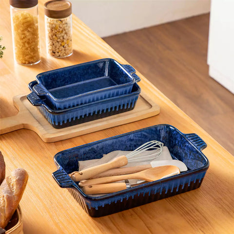 Starry 3 piece stoneware bakeware set with reactive glaze in navy blue on a wooden table