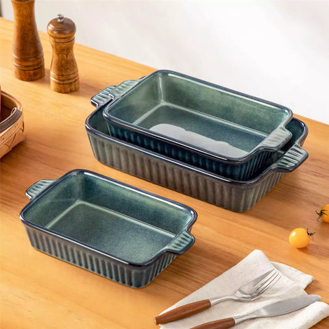 Starry 3 piece stoneware bakeware set with reactive glaze in green on a wooden table