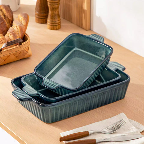 Starry 3 piece stoneware bakeware set with reactive glaze in green on a wooden table