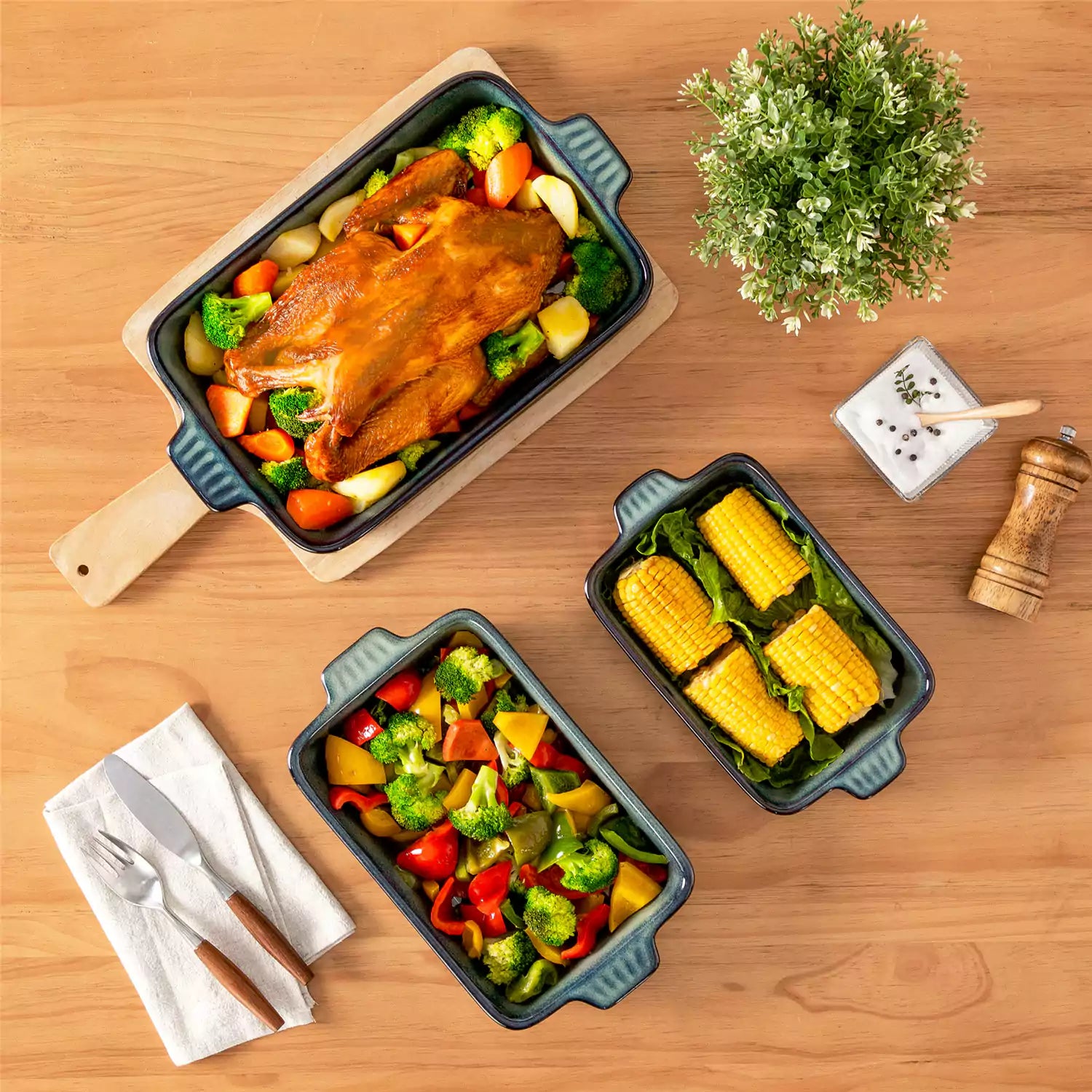 Starry 3 piece stoneware bakeware set with reactive glaze in green on a wooden table