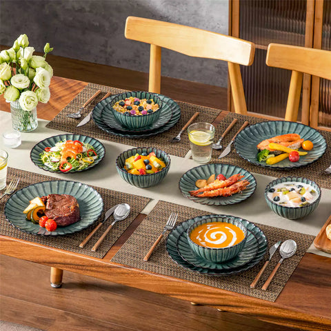 Green reactive glaze stoneware bowls and plates from the Adonis 12 piece set with brown placemats and fresh flowers
