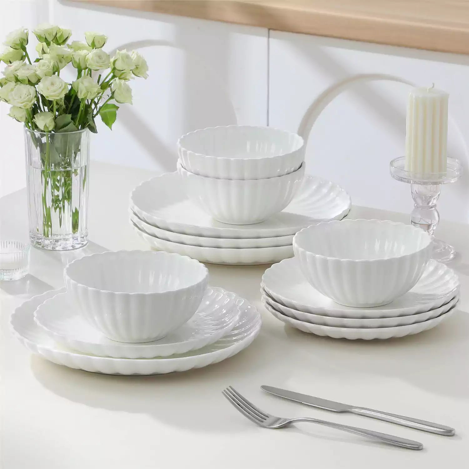 Bright modern dining room with Adonis white porcelain plates bowls white chairs and light wood accents