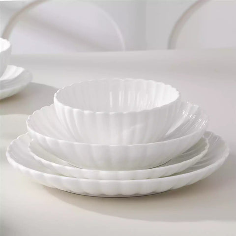 Adonis 24 piece white porcelain dinnerware set for 6 styled with pasta soup and fruit on a modern dining table