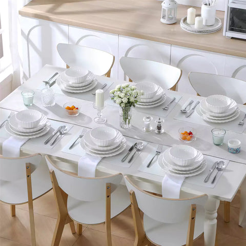 Adonis 24 piece white porcelain dinnerware set for 6 styled with pasta soup and fruit on a modern dining table