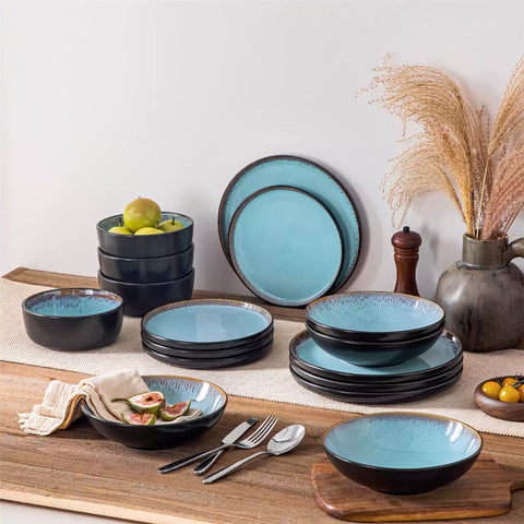 Assorted dishes with soup - dessert - and fruit salad on rustic wooden table - Amber 16-Piece blue stoneware dinnerware set with plates and bowls by vancasso