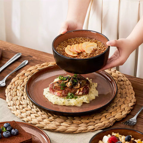 Rustic dining table with Amber 12-piece stoneware dinnerware in farmhouse red - featuring reactive glaze plates - bowls - and utensils by vancasso