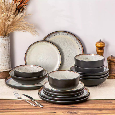 Assorted dishes with soup - dessert - and fruit salad on rustic wooden table - Amber 16-Piece beige stoneware dinnerware set with plates and bowls by vancasso