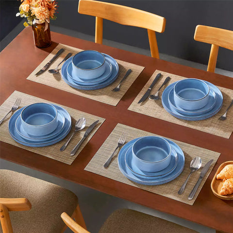 Anya 12 piece straight edge stoneware dinner set in blue with food on a rustic farmhouse wooden table with a side salad and cutlery