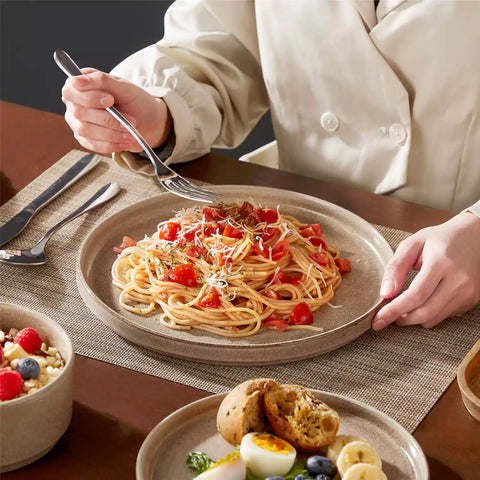 Anya 12 piece straight edge stoneware dinner set in caramel with food on a rustic farmhouse wooden table with a side salad and cutlery