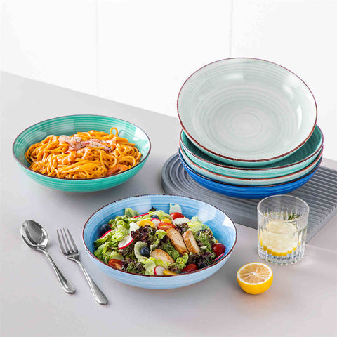 Blue Bonita large stoneware bowls set of 6 on a white table - each filled with pasta - pumpkin soup - and fruit salad - creating a bright and inviting table setting