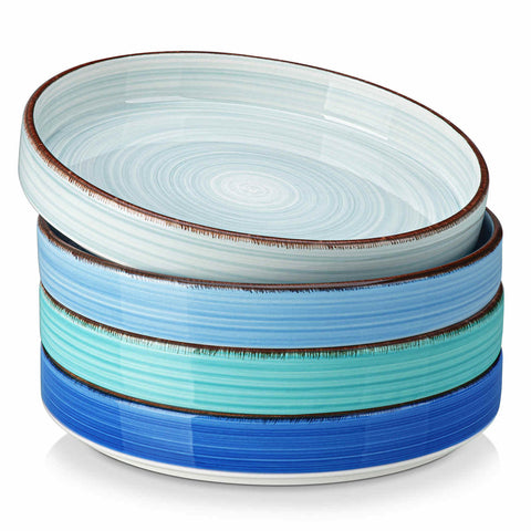 Bonita straight-edge pasta bowls set of 4 on a white table - filled with spaghetti - fruit salad - and mango - accompanied by a small honey jar - ibrant stoneware in ocean blues