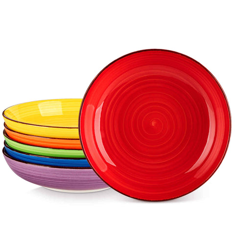 Multicolor Bonita large stoneware bowls set of 6 on a white table - each filled with pasta - pumpkin soup - and fruit salad - creating a bright and inviting table setting