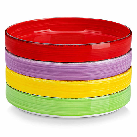Bonita straight-edge pasta bowls set of 4 on a white table - filled with spaghetti - fruit salad - and mango - accompanied by a small honey jar - ibrant stoneware in rainbow blues