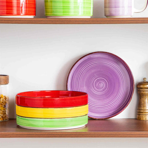 Bonita straight-edge pasta bowls set of 4 on a white table - filled with spaghetti - fruit salad - and mango - accompanied by a small honey jar - ibrant stoneware in rainbow blues
