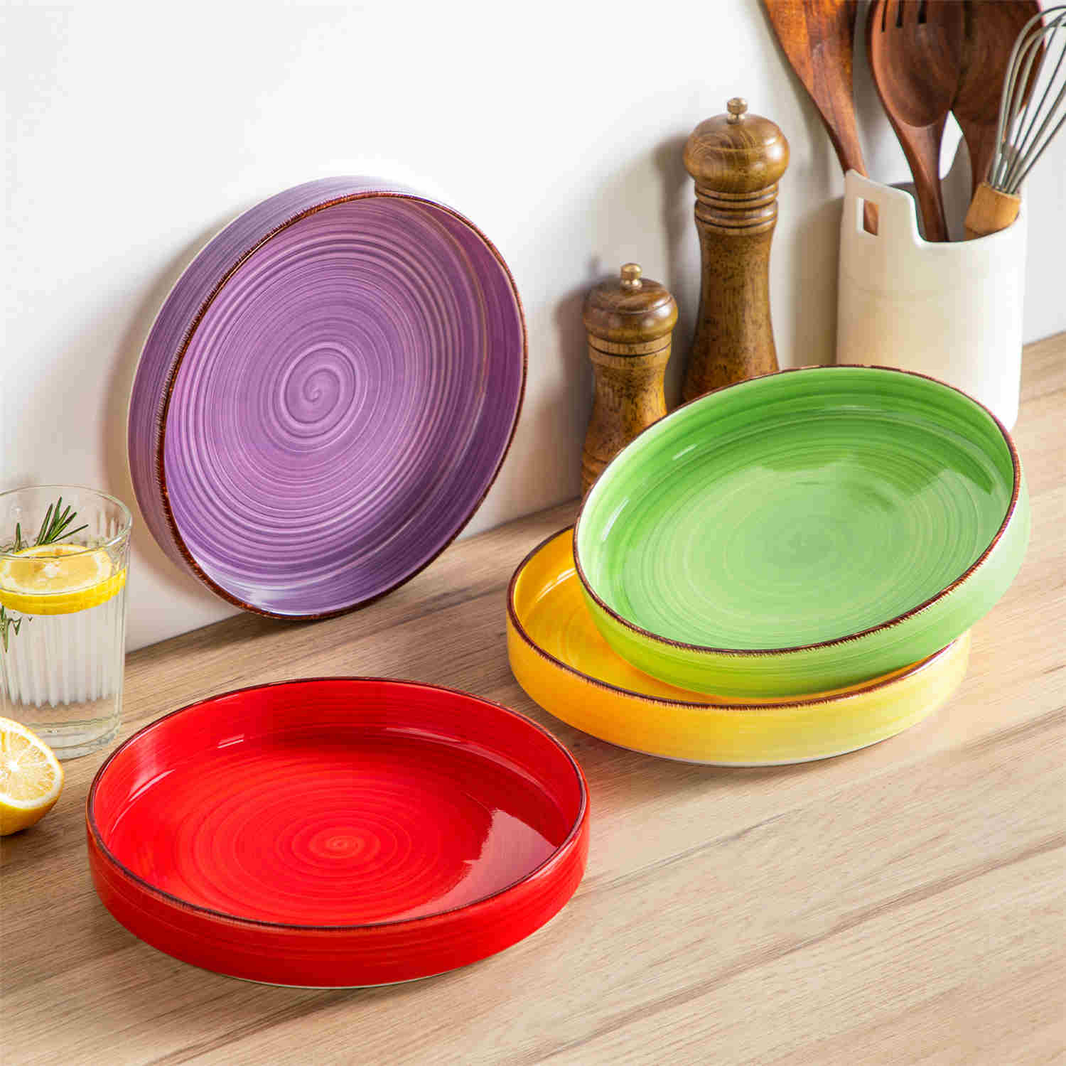 Bonita straight-edge pasta bowls set of 4 on a white table - filled with spaghetti - fruit salad - and mango - accompanied by a small honey jar - ibrant stoneware in rainbow blues