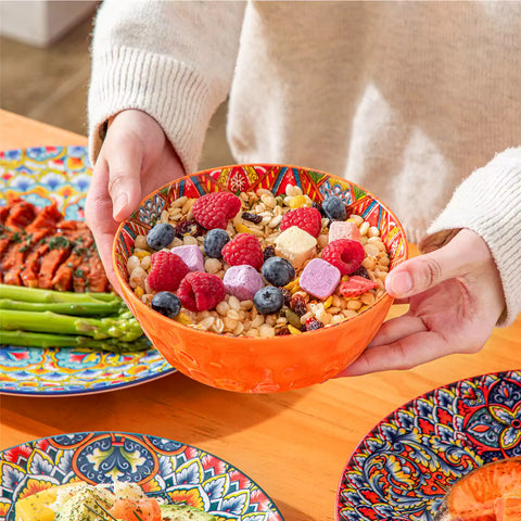 Bohemian Lumi porcelain dinnerware set for 6 with vibrant patterned plates diamond-embossed bowls served with fresh food bread and olive oil on wooden table