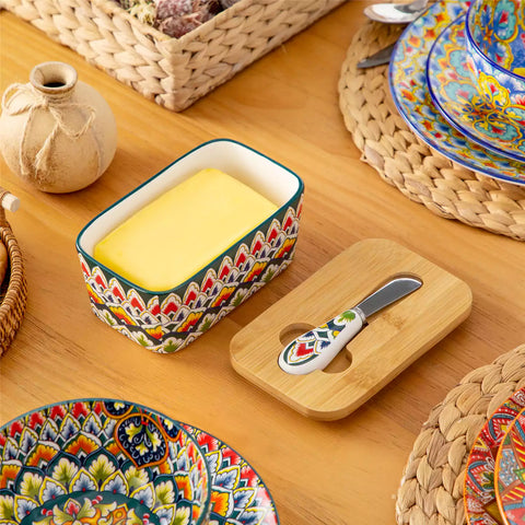 Lumi forest green porcelain butter dish with lid in vibrant Bohemian pattern on a wooden table