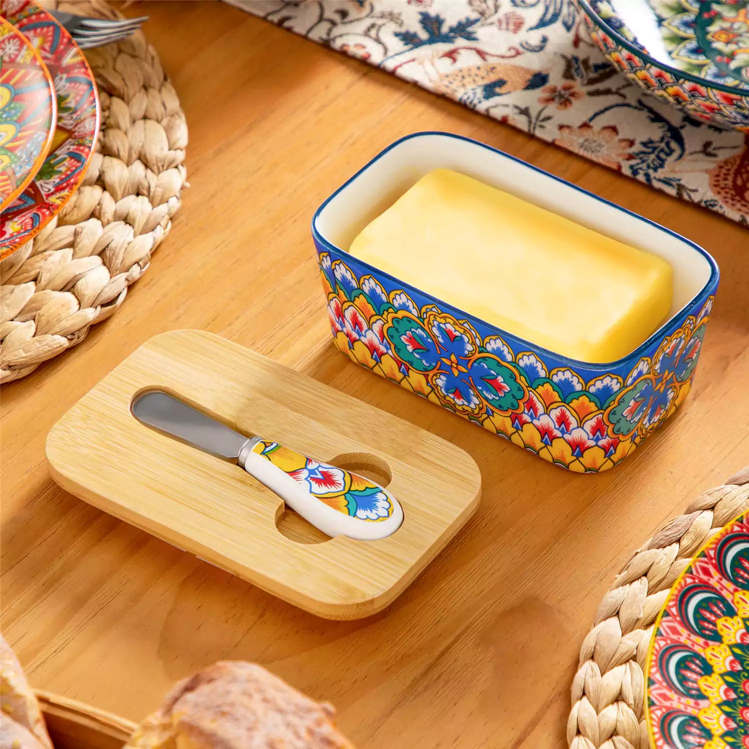 Lumi vibrant blue porcelain butter dish with lid in vibrant Bohemian pattern on a wooden table