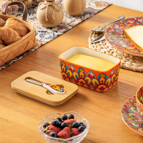 Lumi bold orange porcelain butter dish with lid in vibrant Bohemian pattern on a wooden table