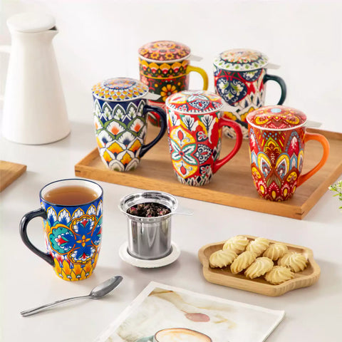 Lumi vibrant blue porcelain tea mug with infuser and lid featuring vibrant Bohemian pattern on a wooden desk with laptop and plant