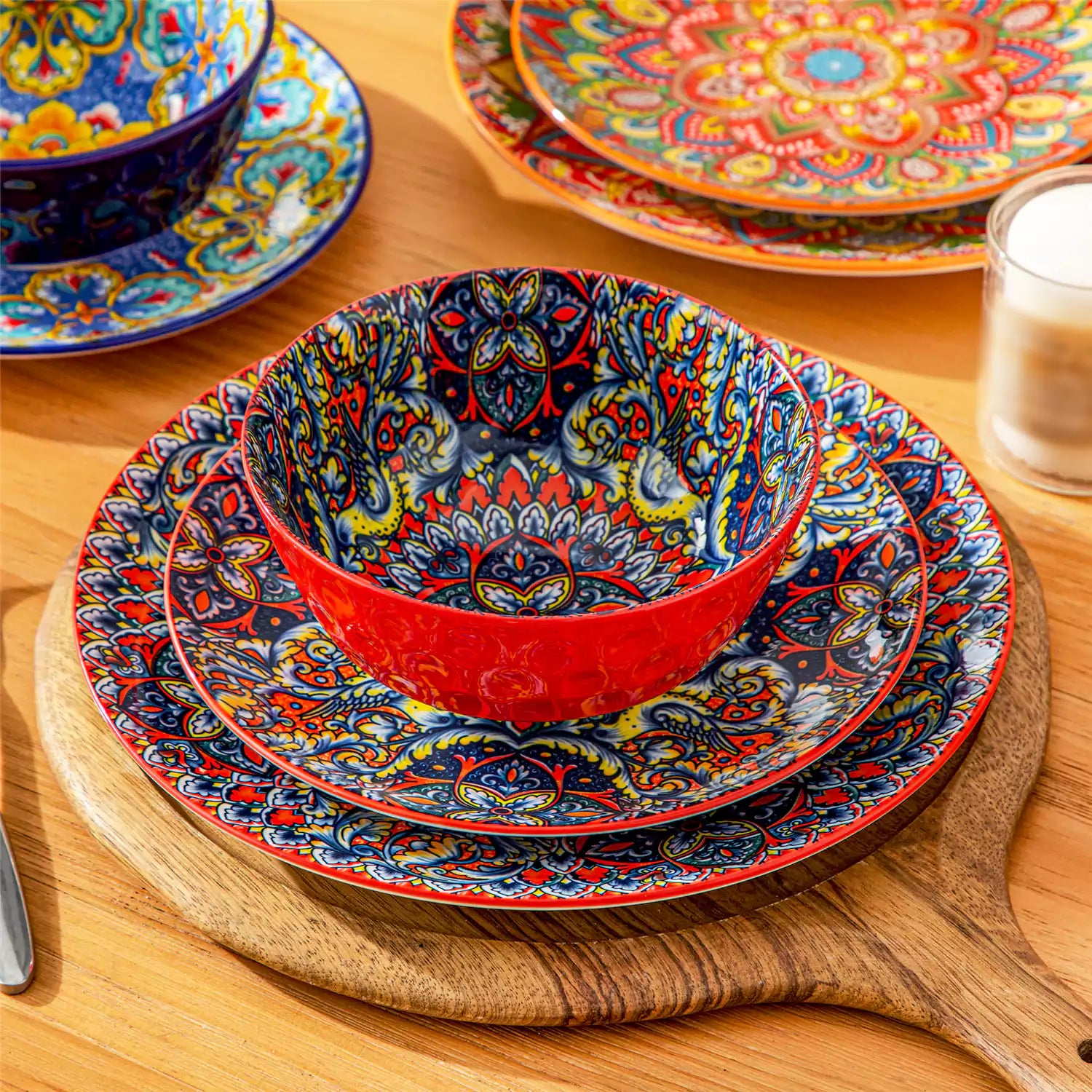 Bohemian Lumi 12 piece porcelain dinnerware set with vibrant patterned plates diamond embossed bowls served with steak eggs and fresh fruit on a wooden table