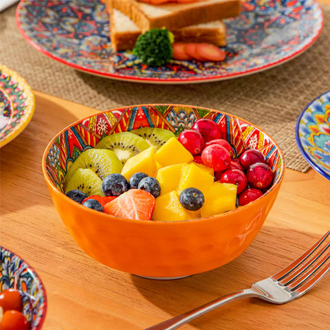 Bohemian Lumi 12 piece porcelain dinnerware set with vibrant patterned plates diamond embossed bowls served with steak eggs and fresh fruit on a wooden table