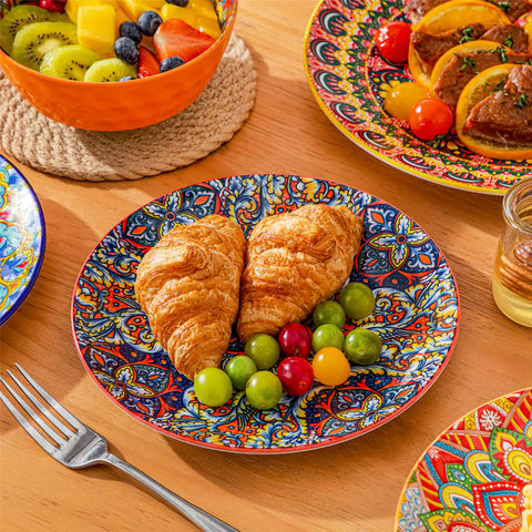 Bohemian Lumi 12 piece porcelain dinnerware set with vibrant patterned plates diamond embossed bowls served with steak eggs and fresh fruit on a wooden table