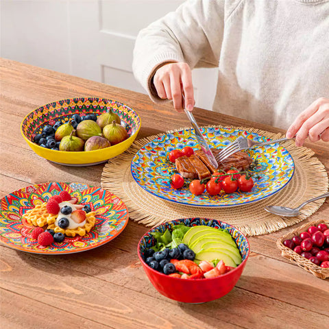Bohemian Lumi 16 piece porcelain dinnerware set with colorful patterned plates and diamond-embossed bowls on a wooden table with assorted food and cutlery
