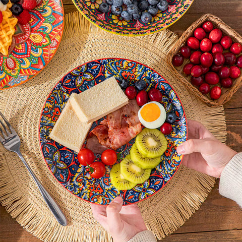 Bohemian Lumi 16 piece porcelain dinnerware set with colorful patterned plates and diamond-embossed bowls on a wooden table with assorted food and cutlery