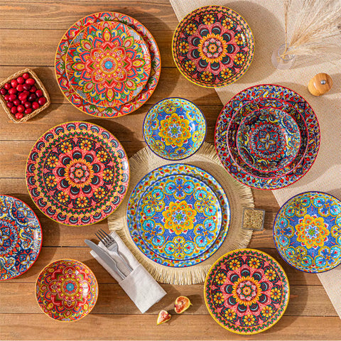 Bohemian Lumi 16 piece porcelain dinnerware set with colorful patterned plates and diamond-embossed bowls on a wooden table with assorted food and cutlery