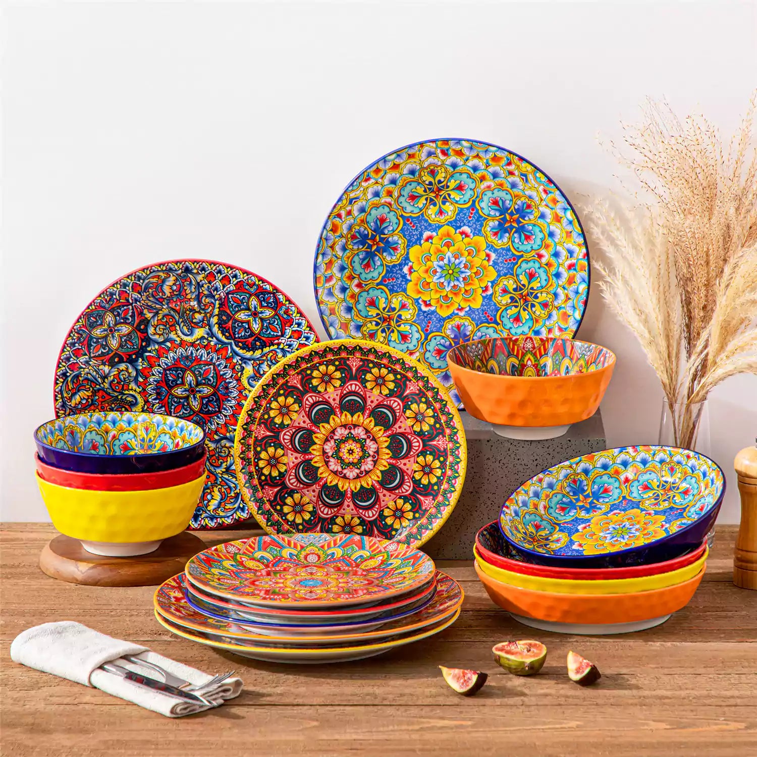 Bohemian Lumi 16 piece porcelain dinnerware set with colorful patterned plates and diamond-embossed bowls on a wooden table with assorted food and cutlery