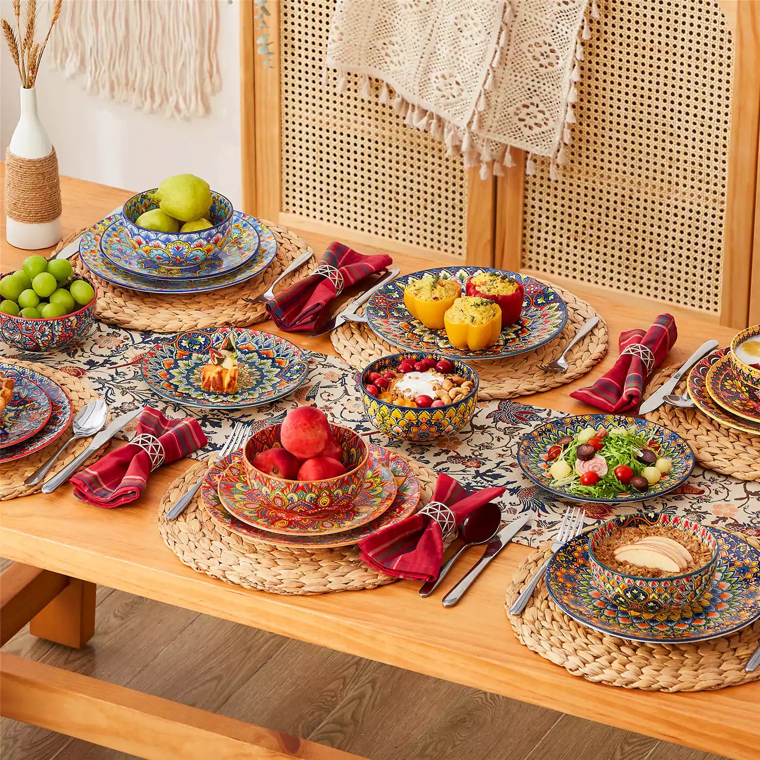 Lumi 18-piece Bohemian dinnerware set for six on a wooden table with colorful plates bowls and silverware in a playful Boho style