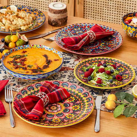 Bohemian style dining table set with Lumi 24 piece colorful dinnerware bowls and vibrant table décor ready for a lively meal