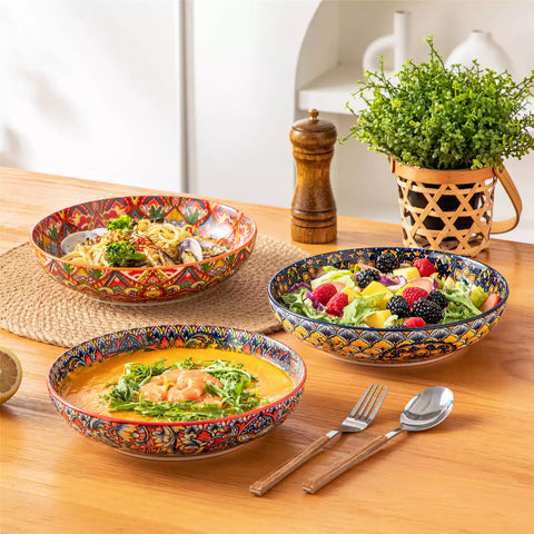 Vibrant Lumi porcelain pasta bowls filled with fruit salad pumpkin soup and pasta on a wooden dining table